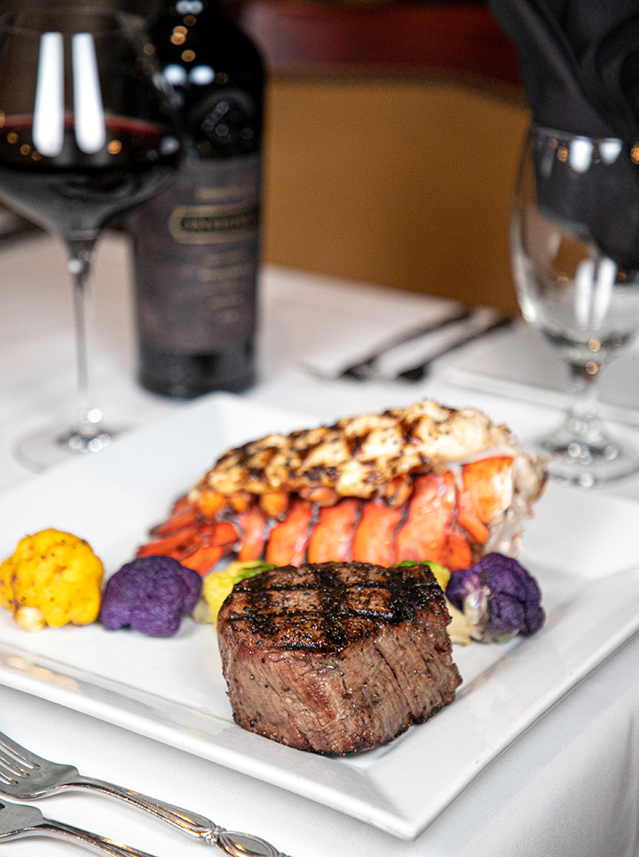Steak and Lobster with a glass of wine